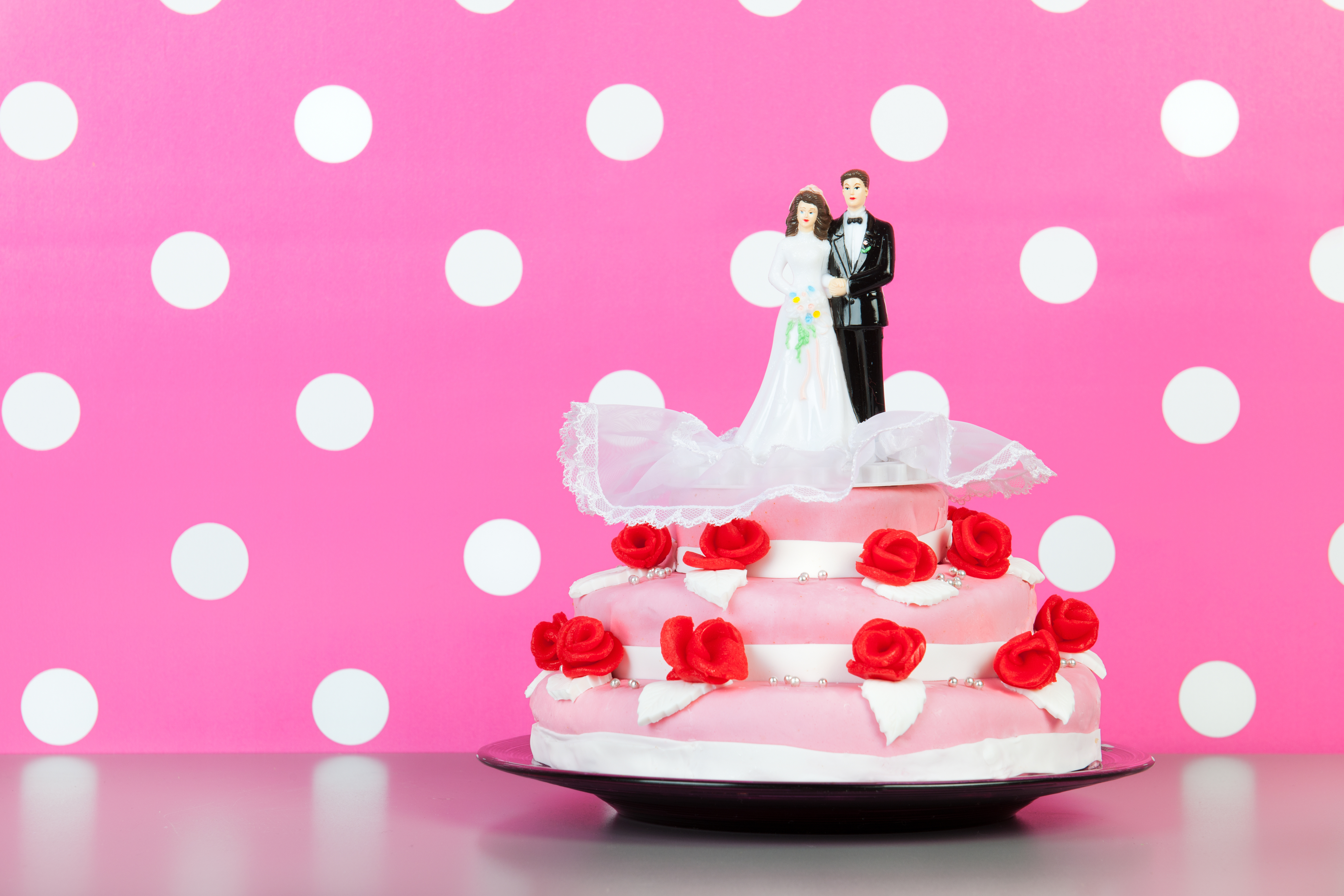 Couple on top of wedding cake